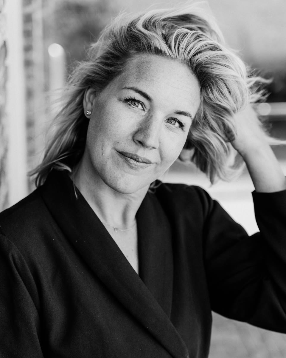 Zwart-witportret van Robin Visser-Ardon, hand in haar haar, met een open, directe blik